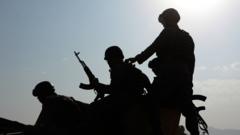 Afghan security personnel on a military vehicle at the site of an attack by Taliban militants in Kabul on October 6, 2015.